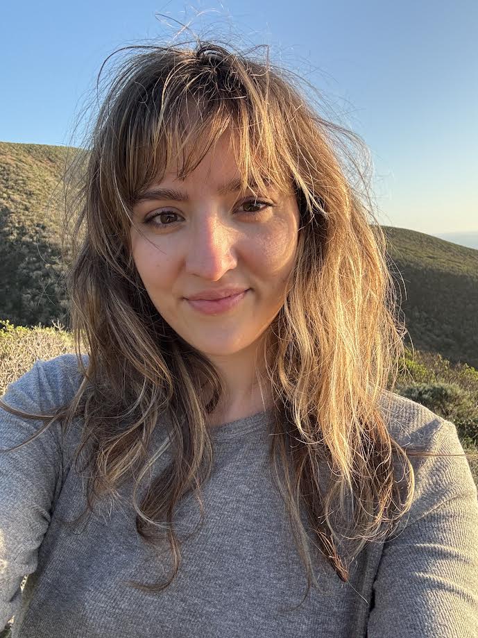 Eythana Miller standing near the coast.